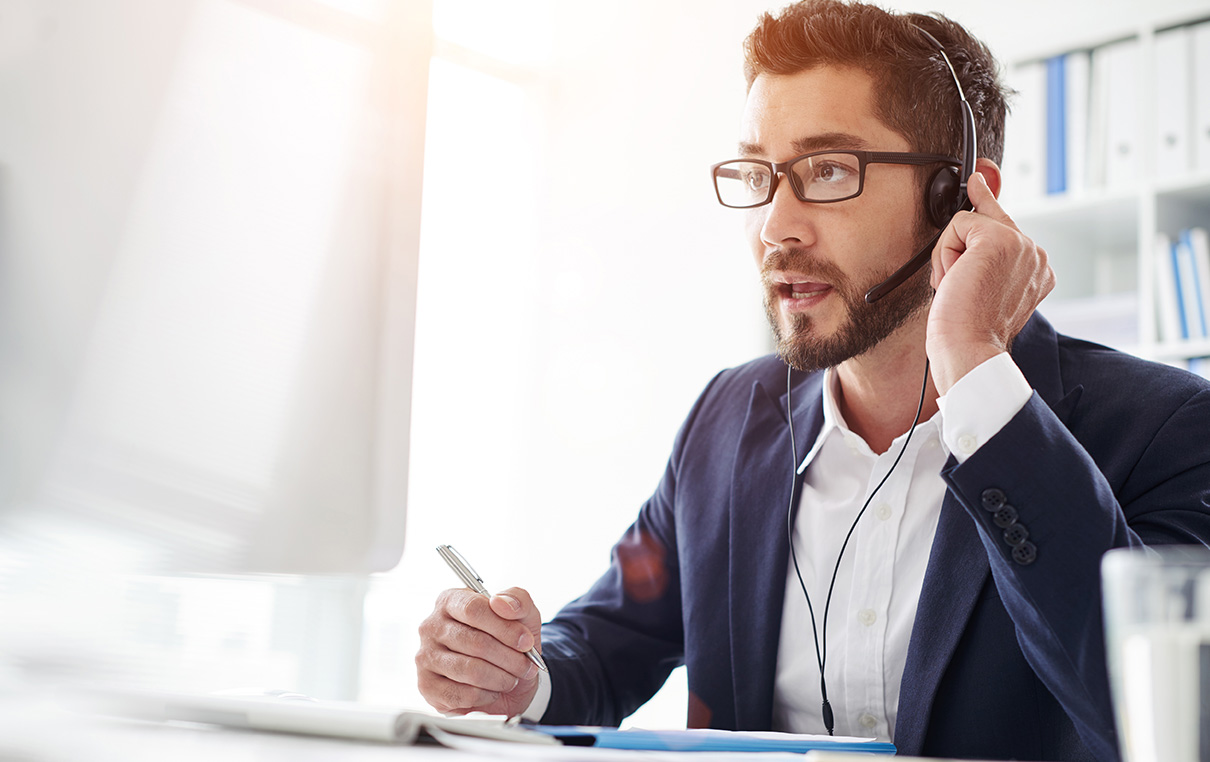 customer service associate from emo trans speaking through headset to customer