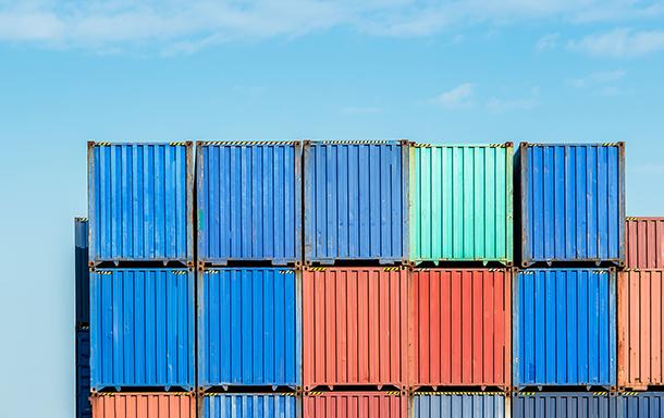 multicolored shipping containers stacked to be imported or exported 