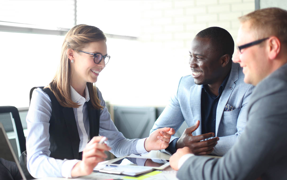 group of business professionals discussing information during a meeting 