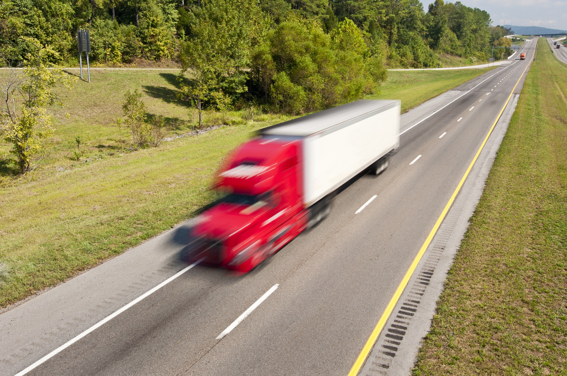 semi truck speeding down the two lane interstate highway 