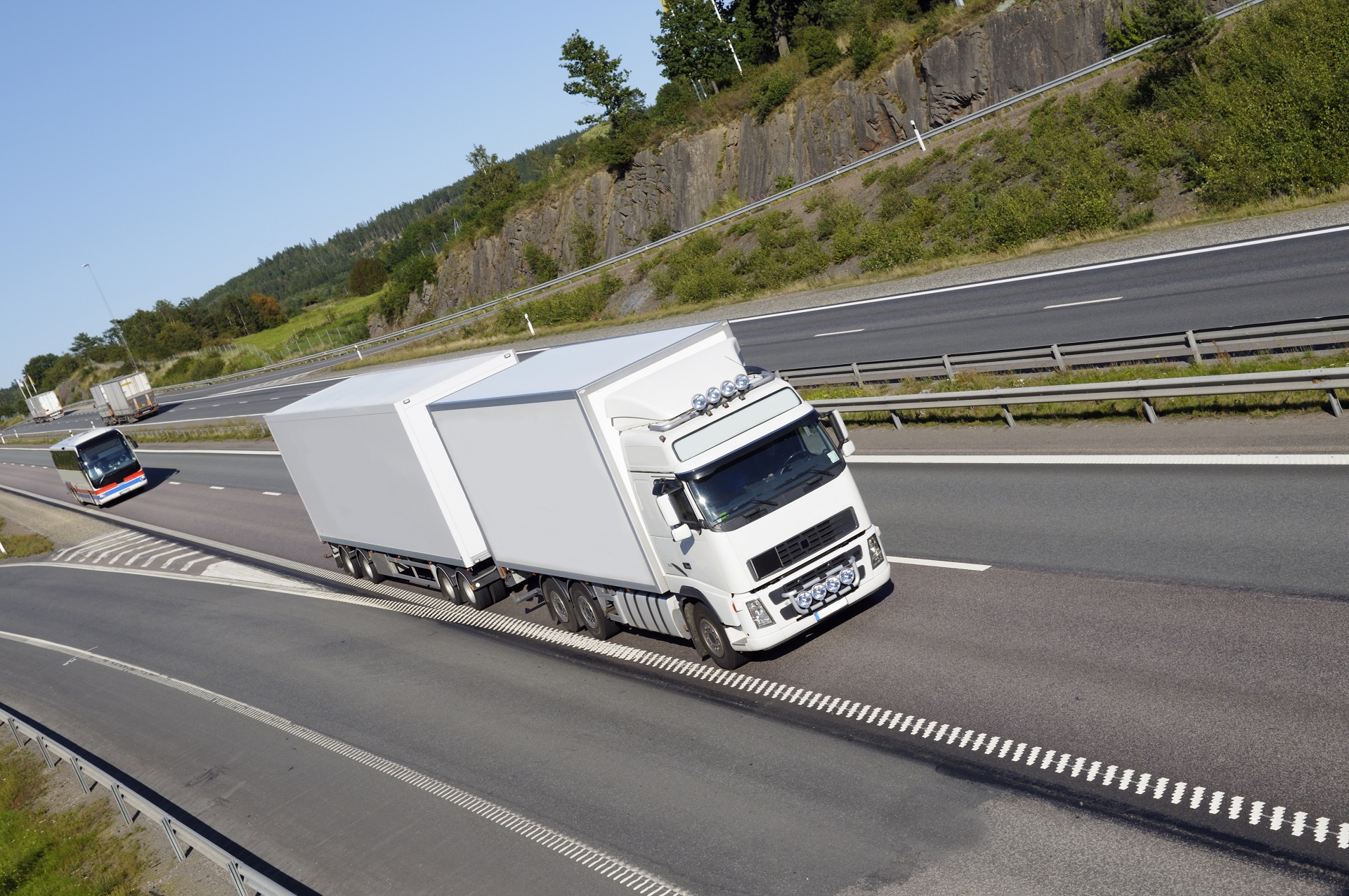 semi truck hauling a double load of cargo along an interstate highway 