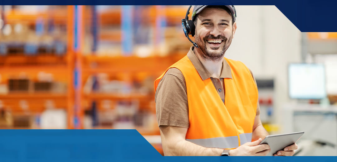 A man in a high-vis vest smiles